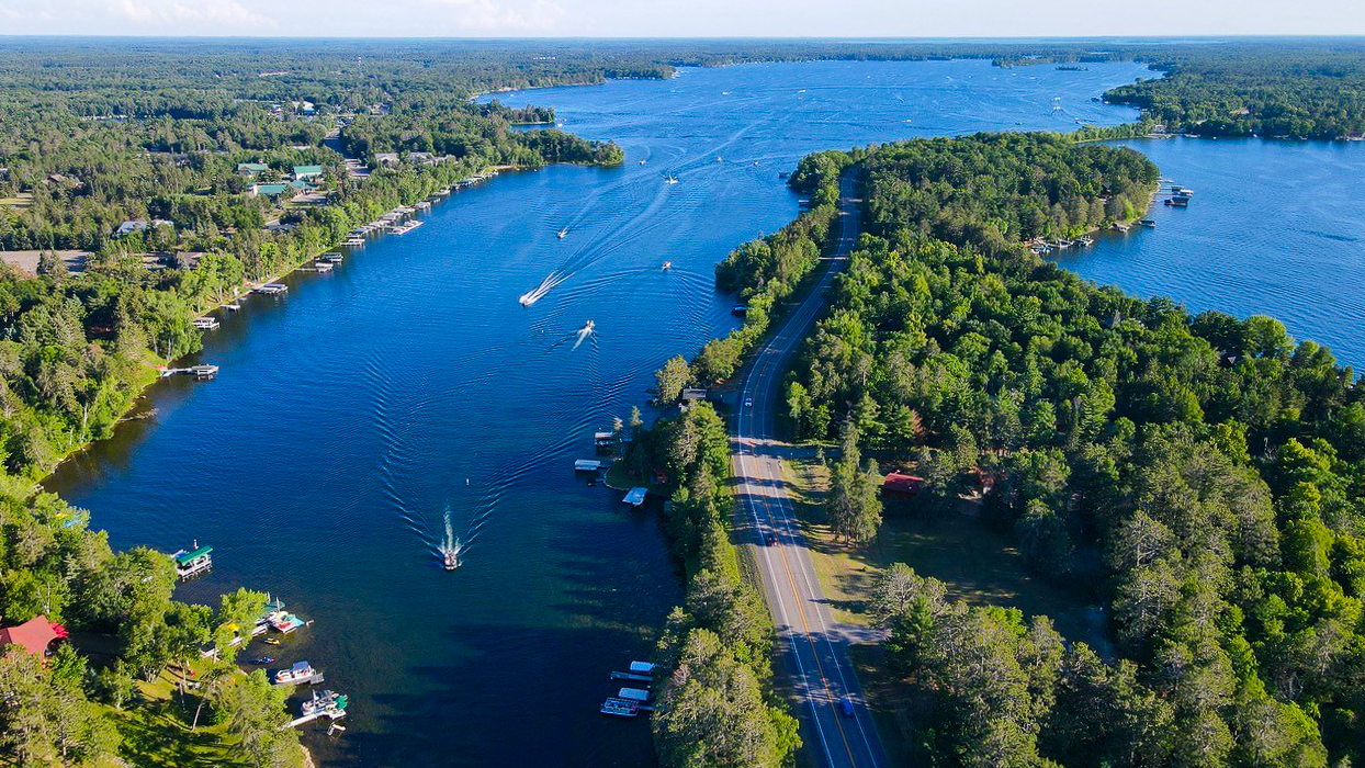 An aerial view of the Whitefish Chain located in Crosslake MN with boats heading towards a lakeside restaurant